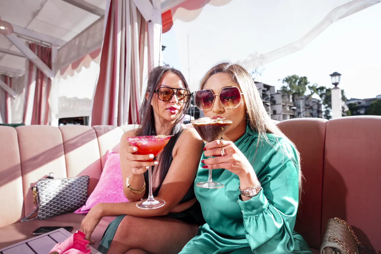 The dockside patio at Nigel's at Anchors Away: pink cabana, cocktails, the marina beyond