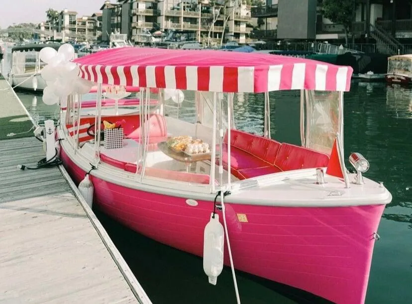 Anchors Away Signature Pink Duffy with a striped canopy at Marina Pacifica